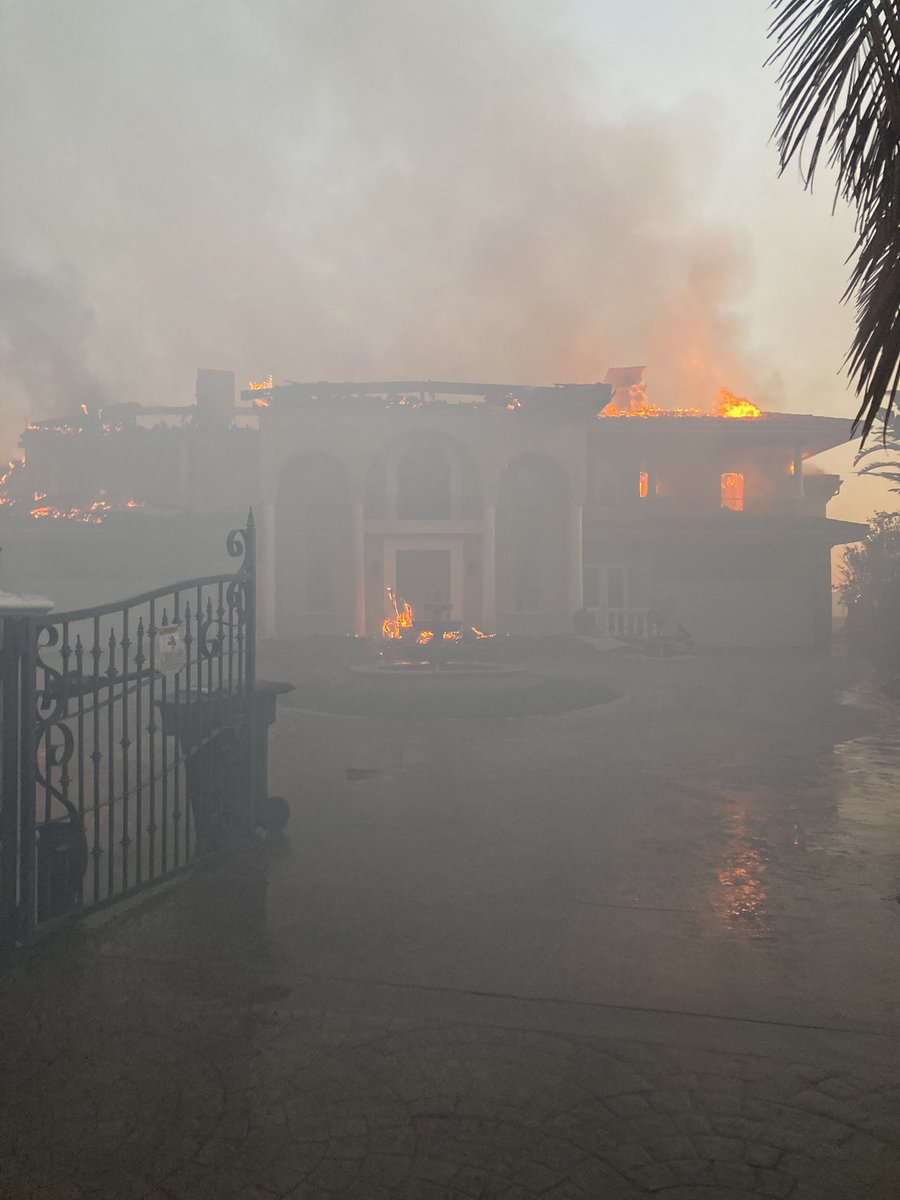 Homes burning on the top of the bluff above Pacific Island