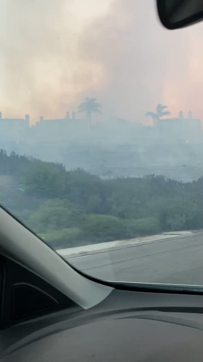 Charred hillsides along Pacific Island Drive. Flames still burning