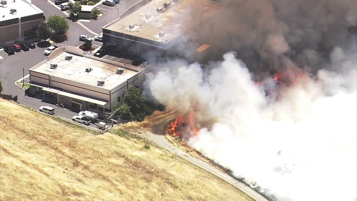 The brush fire burning off of Highway 4 near Concord came close to some buildings, but firefighters appear to have gained the upper hand