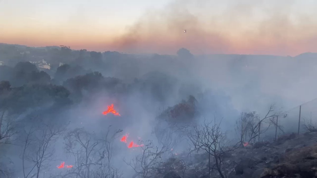 BridgeFire - - SBCASU Copter 964 makes a water drop on flames near Cathedral Oaks & Hwy 154