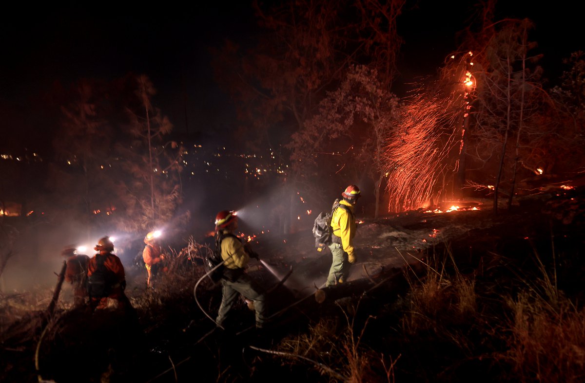 Crews work to tie in containment lines on the steep slopes of the PointFire near Lower Lake, Ca., Saturday evening