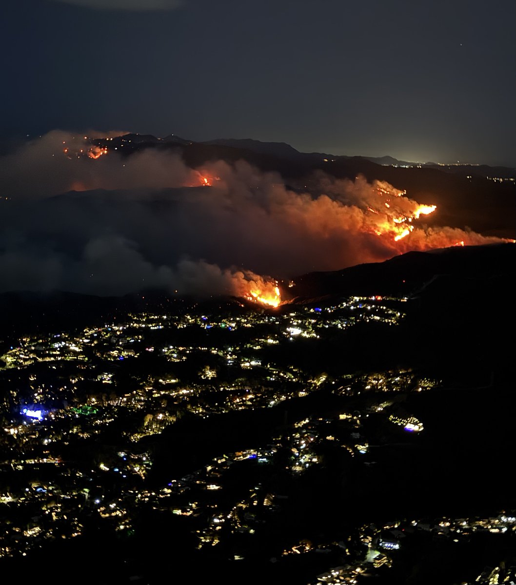 This is a shot of the hilltops near Mandeville Canyon over Brentwood, CA where the Palisades Fire is burning dangerously close