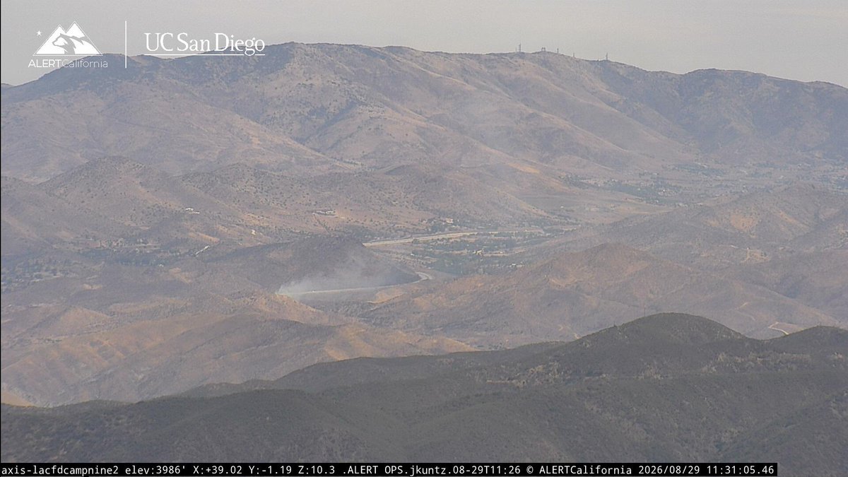 Agua Dulce Ca:14 Freeway At Agua Dulce Canyon Rd)Brush fire at location approximately 1/2 an acre burning downhill.1 copter overhead,LACoFD sending a 1st alarm brush response