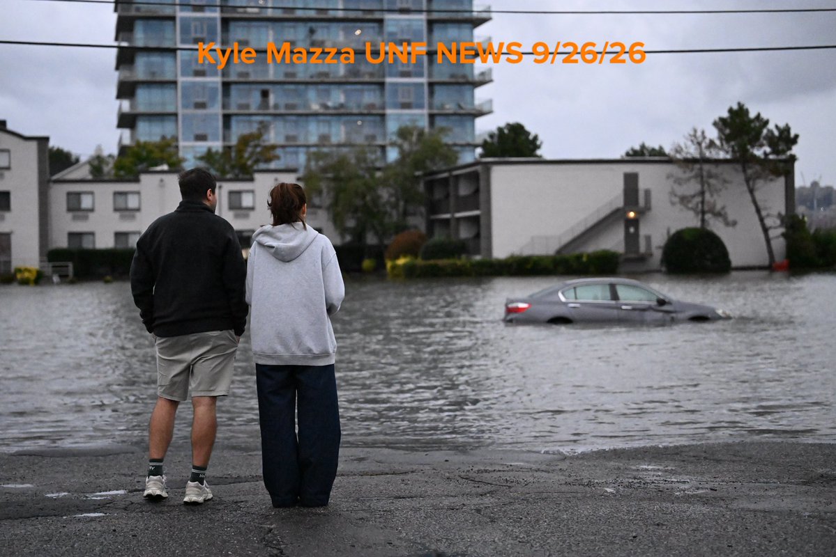 Vehicles are seen submerged in floodwaters in a parking lot along the Hudson River during a nor'easter storm in Edgewater, New Jersey